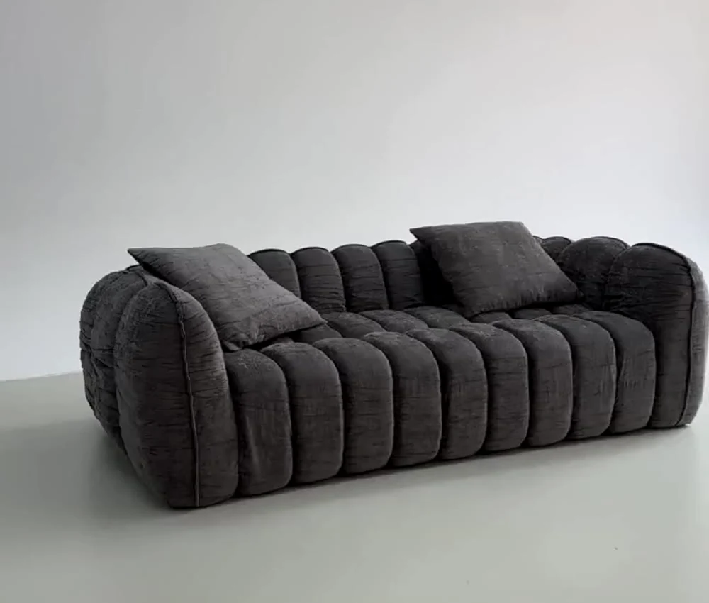 Charcoal upholstered sofa photographed from a real product video