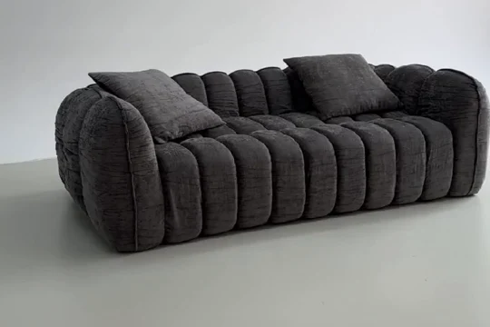 Charcoal sofa after unpacking in a product demonstration